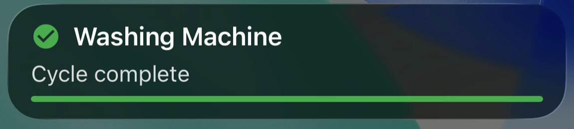 Washing Machine Live Activity showing "Cycle complete" with a full green progress bar